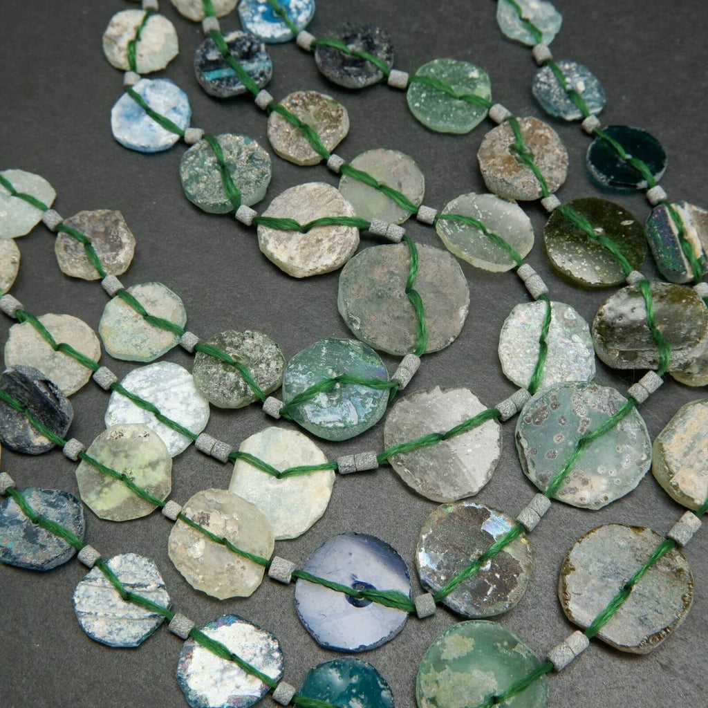 Roman glass graduated coin shape beads.