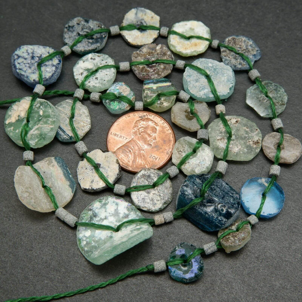 Roman glass graduated coin shape beads.