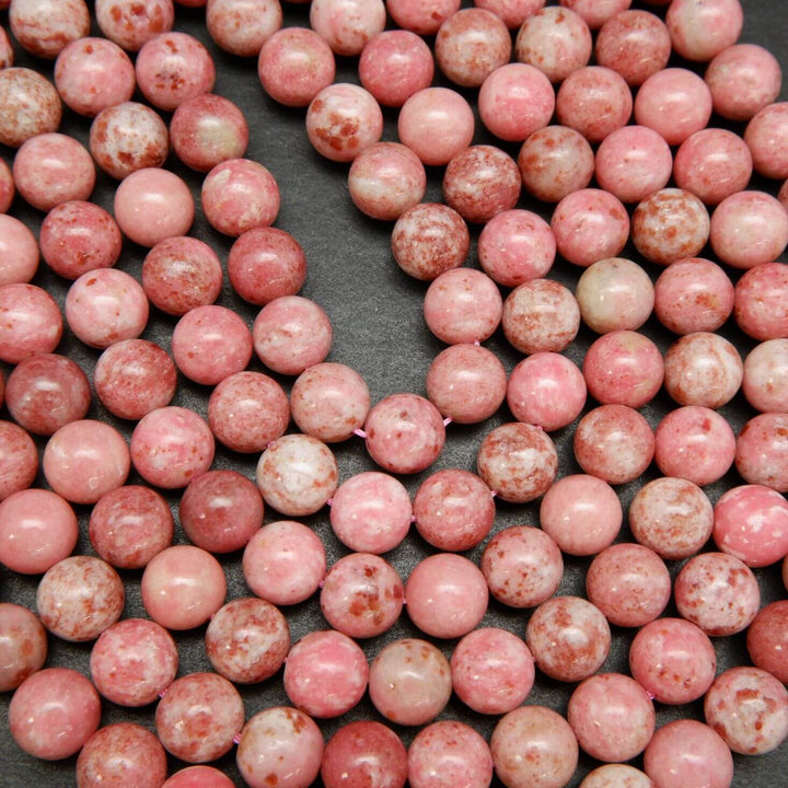 Natural pink thulite beads speckled with deep pink