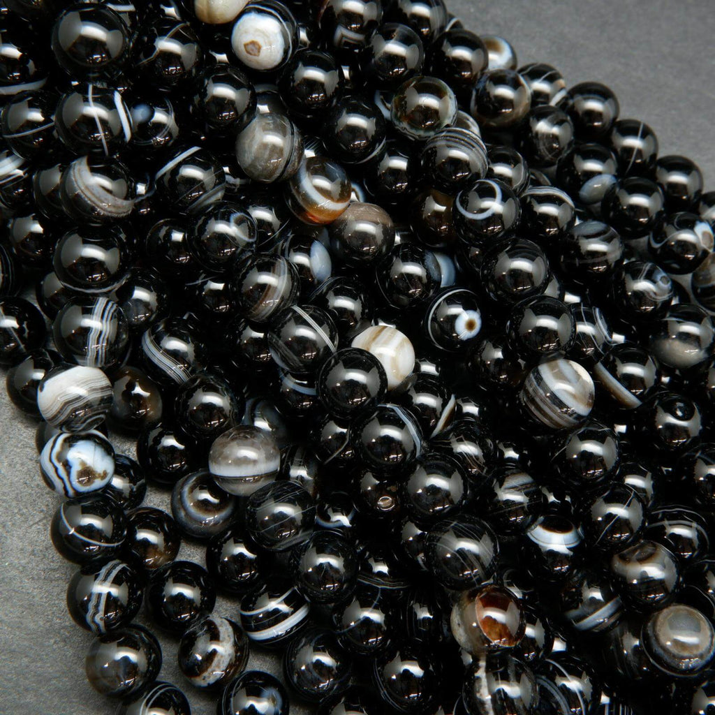 Black banded sardonyx agate large hole beads. Black polished round beads with white rings.