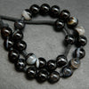 Black banded sardonyx agate large hole beads. Black polished round beads with white rings.