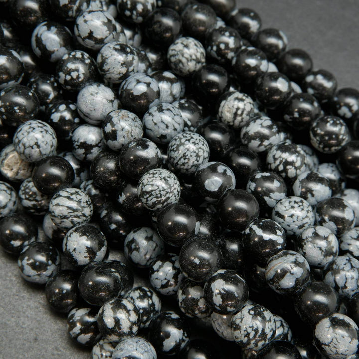 Snowflake-Obsidian-Beads. Large hole beads with snow like ash inclusions.