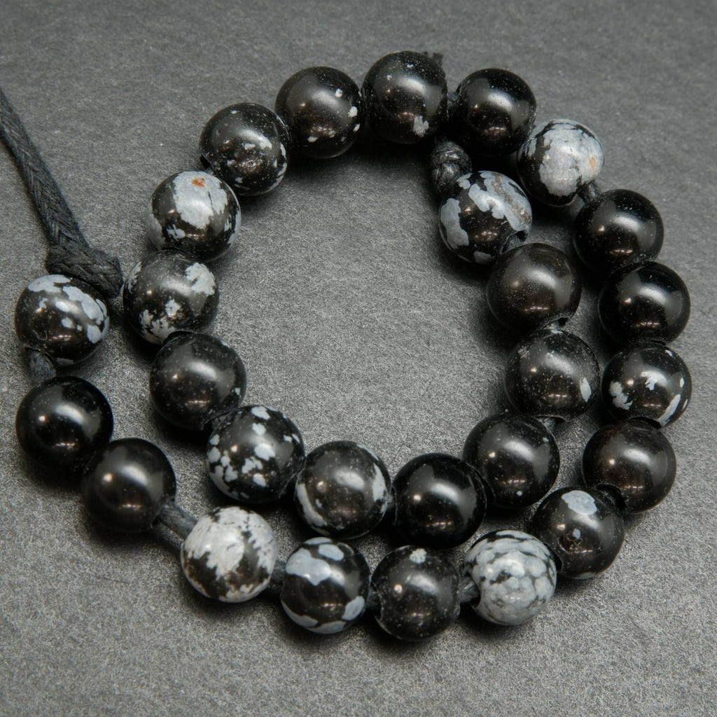 Snowflake-Obsidian-Beads. Large hole beads with snow like ash inclusions.