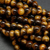 Yellow and brown tones in these polished round tiger's eye beads.