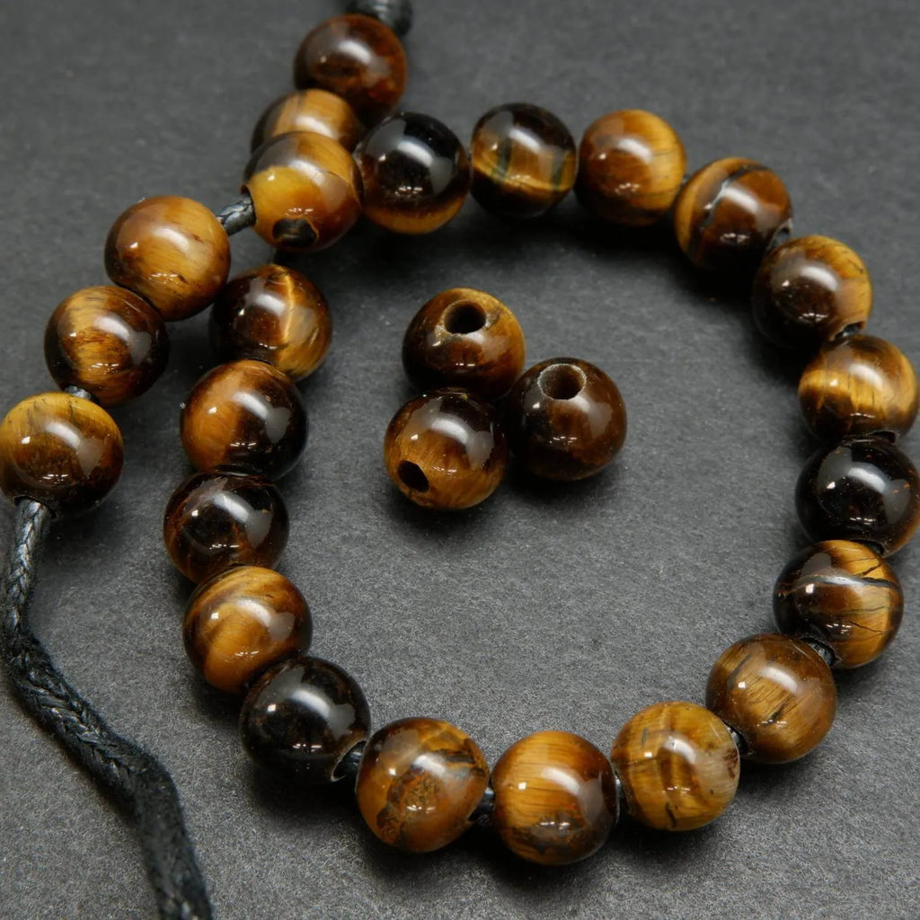 Yellow and brown tones in these polished round tiger's eye beads.