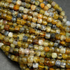 Yellow dendritic opal cube shape beads.