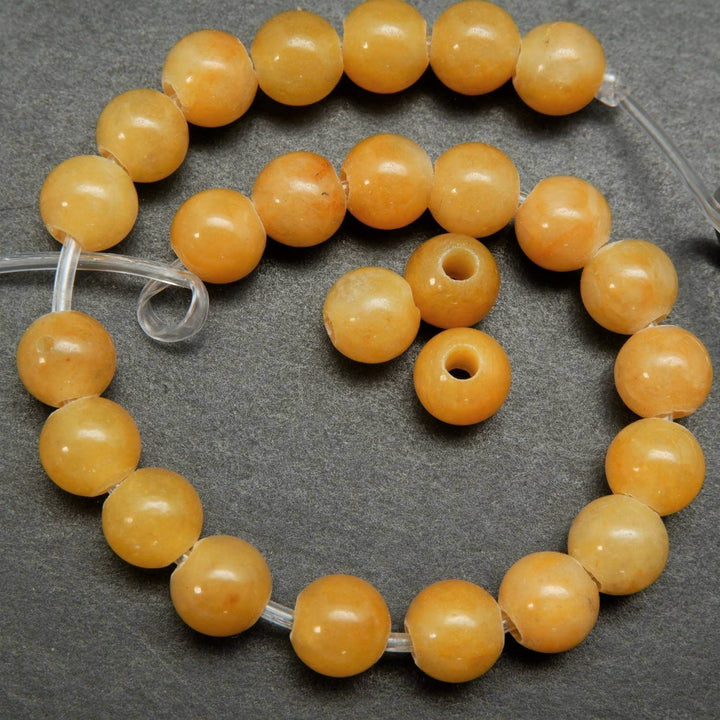 Yellow jade large hole loose beads.