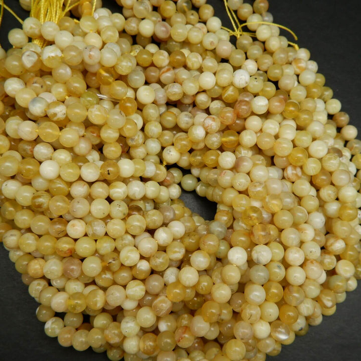 Natural Yellow Opal Beads. Round yellow beads on a string for jewelry making.